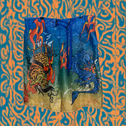 Colorful shorts with dragon and tiger design on a white background